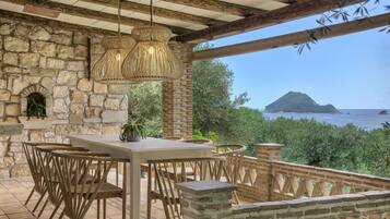 Enjoy al fresco dining with a view of the sea and a distant island from this outdoor patio.