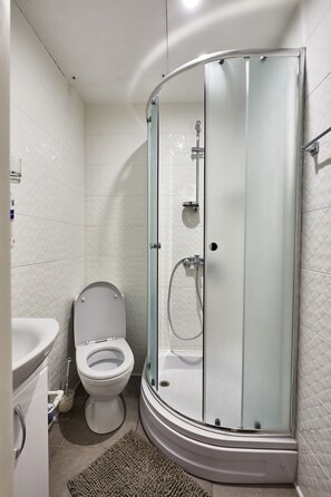 Shower, hair dryer, slippers, towels