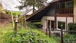 A rustic house with a sloped roof, a balcony, and a satellite dish. - Eifelnatur (Haus 2) by Interhome (Immerath)