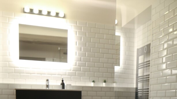 A bathroom with white subway tiles, a black vanity, a mirror with lights, a bathtub, and a window with blinds. - House Alberta Superb T2 in the city center (Aix-en-Provence)
