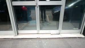 A building entrance with a glass door and a small step leading up to it. - --- SEA AND BOATS ---- (Le Portel)