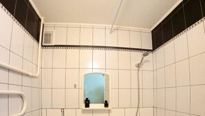 A small, compact bathroom with a toilet, sink, and bathtub. - Flatsis Apartment Otakara Yarosha 33 (Kharkiv)