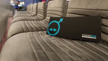 A row of upholstered seats with a black box labeled "Sonderbar" on one of them.
