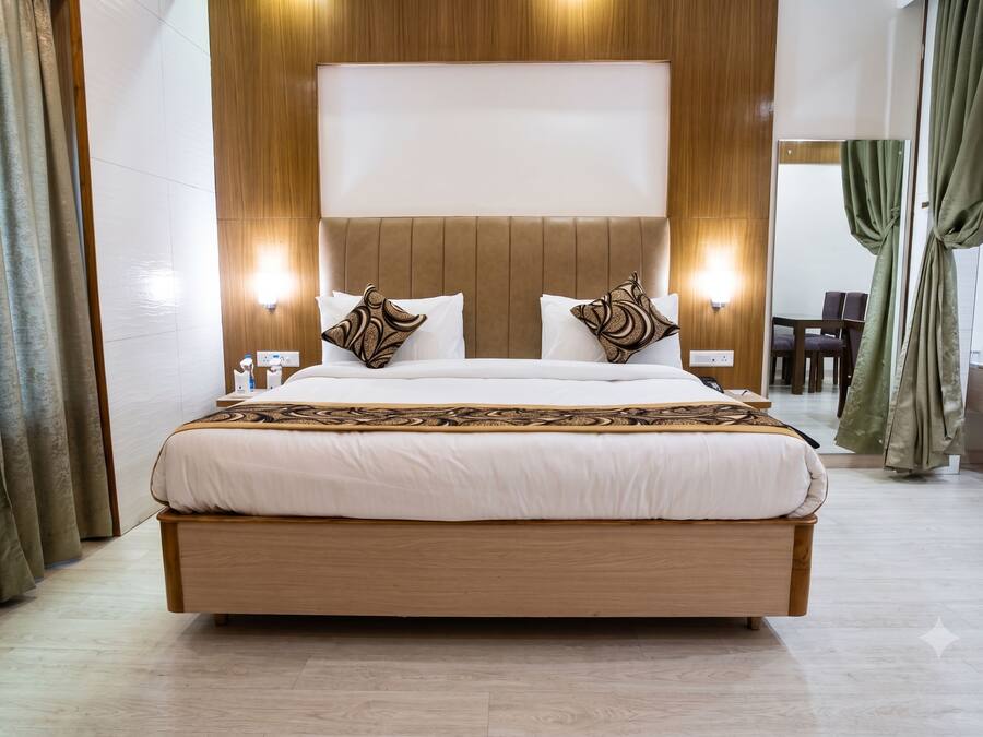 A large bed with a wooden frame, two bedside tables, and a headboard with integrated lighting.