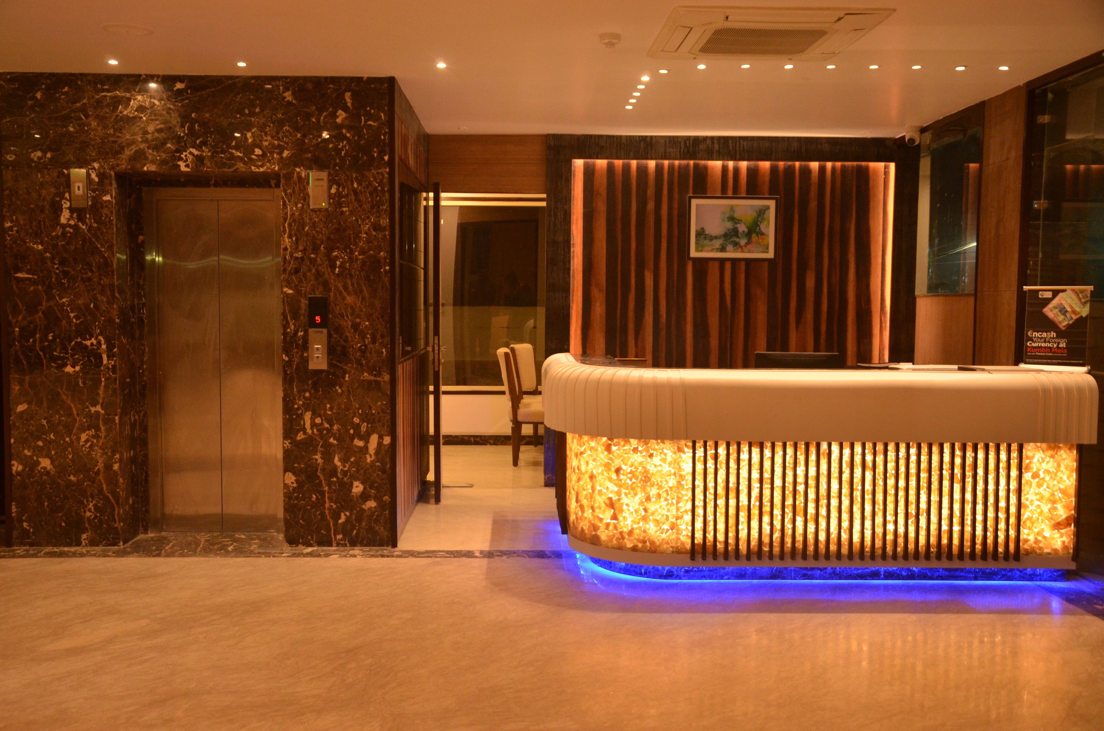 A reception area with a reception desk, a reception counter, and an elevator.