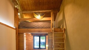 A compact room with a bunk bed, a wooden ladder, a table, and a window. - La Grange d'Emile Gites, Roulottes et Piscine (Blandas)