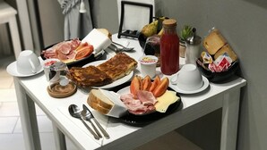 Un bufé de desayuno con diversos alimentos y salsas sobre una mesa.