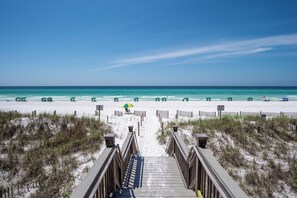 A beach with a wooden boardwalk leading to the water, surrounded by sand dunes. - ~Fleur De Seas~Private Pool! Sleeps 16 ~ (Miramar Beach)
