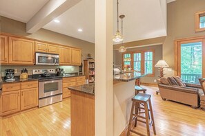 Dishwasher, coffee/tea maker, cookware/dishes/utensils, dining tables