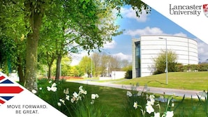 A campus with a modern building, green lawns, and white flowers. - The Clarendon Hotel (Morecambe)