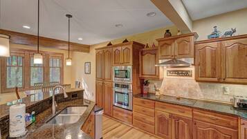 Dishwasher, coffee/tea maker, cookware/dishes/utensils, dining tables