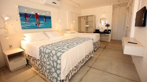 A hotel room with a bed, bedside tables, a TV, a mirror, a wardrobe, and a bathroom with a sink and mirror. - Saint Germain Kite Residence (Amontada)