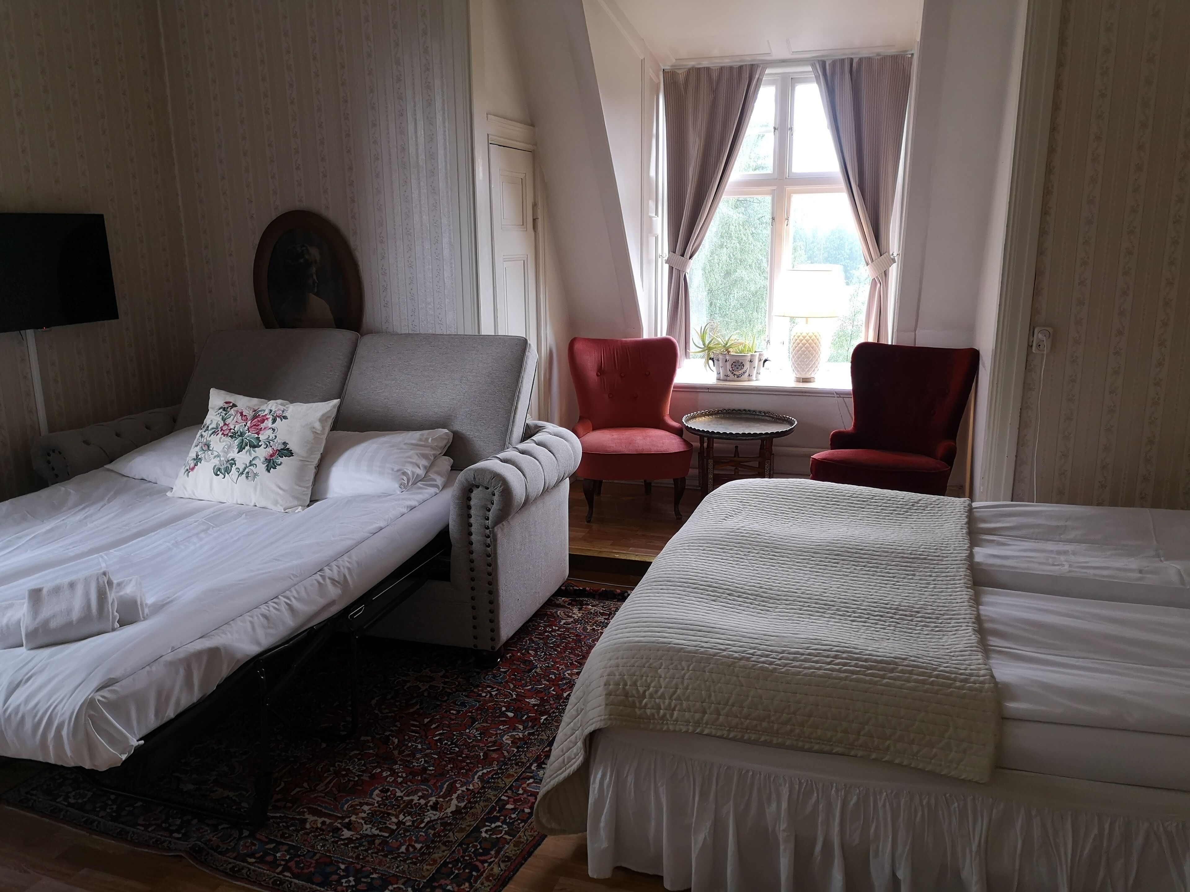 family room | desk, laptop workspace, blackout curtains, cots/infant beds