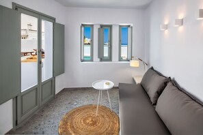 Anafi Suite , Deluxe suite 2 with sea view and hot tub | Living area | 42-inch Smart TV with satellite channels, TV - Seven Suites (Santorini)