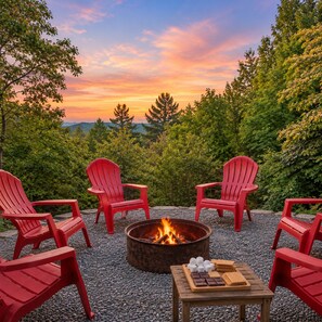A fire pit with red Adirondack chairs and a table with marshmallows and chocolate. - Call of the Wild, Blue Ridge, GA (Morganton)
