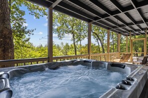 A hot tub with a wooden deck and a view of trees. - Top of Mountain Views, Pet Friendly, Fenced Yard (Morganton)