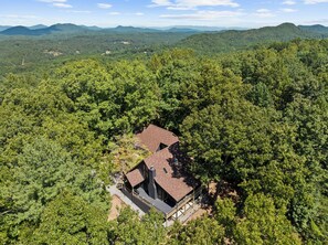 A house surrounded by dense forest with a clear view of the surrounding hills. - Top of Mountain Views, Pet Friendly, Fenced Yard (Morganton)