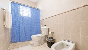 A bathroom with a toilet, bidet, and a trash bin. - Colinas del Atlantico for 18 People (Isabela)