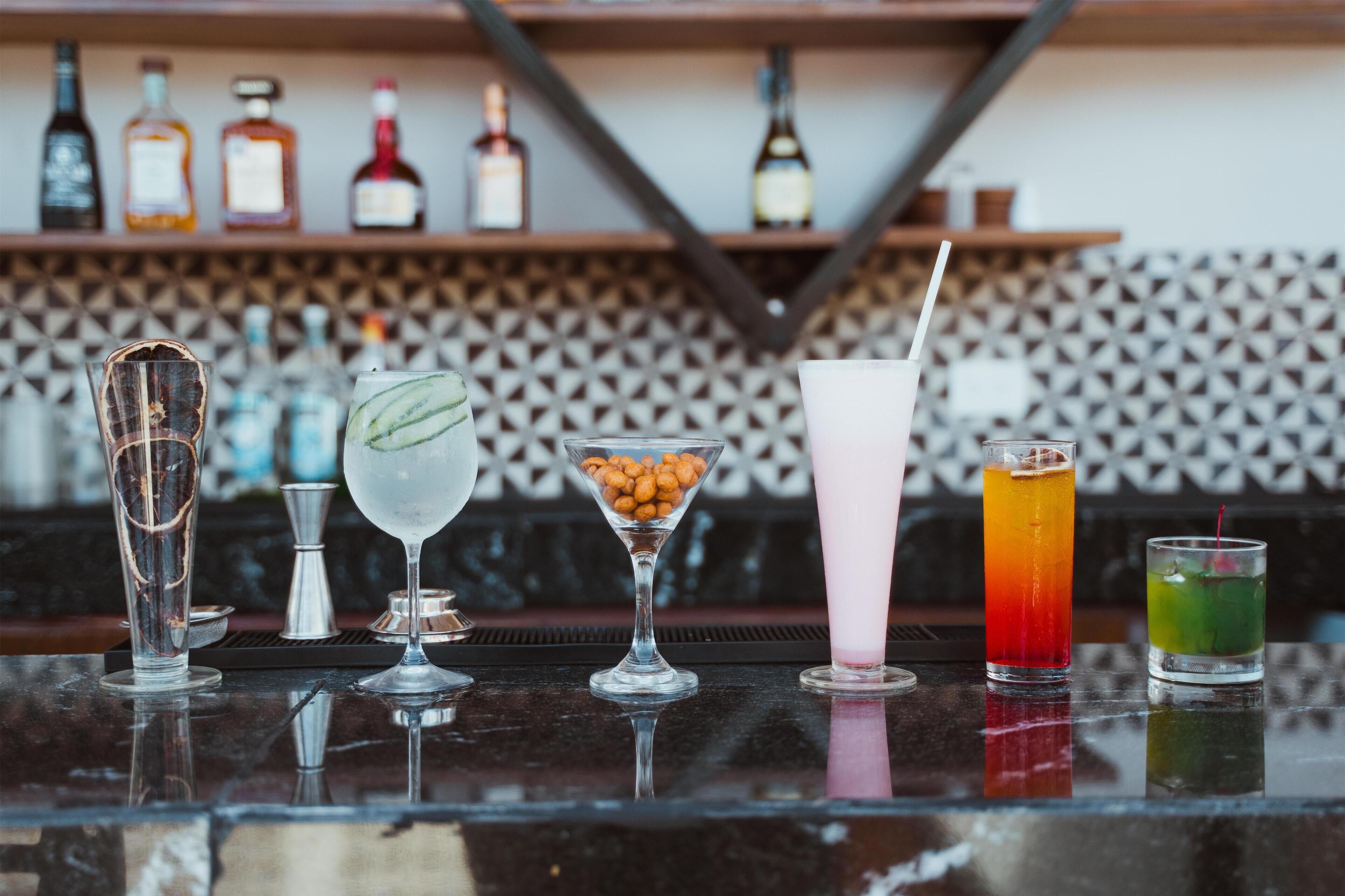 A bar with various drinks and bottles on shelves.