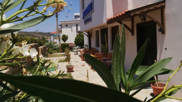 Uma rua estreita com um edifício ostentando uma placa que diz 'Hotel'.