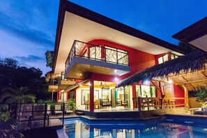 A modern two-story house with a swimming pool, large windows, and a balcony. - Vista Oceana, Stunning Ocean View Villa (Quepos)