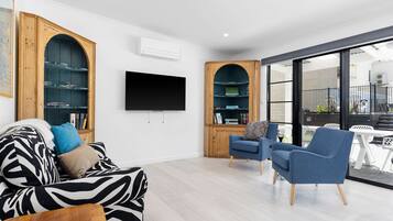 Premium Apartment, Multiple Beds, Pool View | Living area | Flat-screen TV