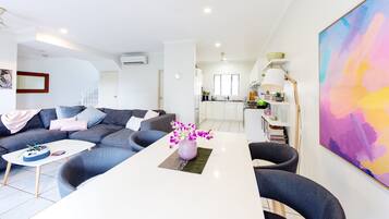 Deluxe Apartment, 3 Bedrooms, Beach View | Living area | Flat-screen TV