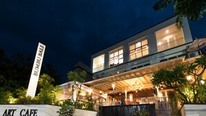A modern building with a sign reading "BUMBU BALI ART CAFE".