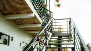 A staircase with metal railings and a bamboo ceiling. - Tam Coc Mandala Villa & Homestay  (Nam Hoa Lu)