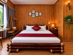 A room with a bed, a bedside table, a lamp, a plant, and a window with curtains. - Tam Coc Mandala Homestay & Pool (Nam Hoa Lu)