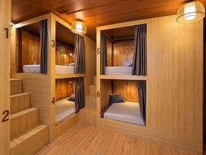 A room with bunk beds numbered 1 to 6, wooden walls, and a staircase. - Tam Coc Mandala Homestay & Pool (Nam Hoa Lu)