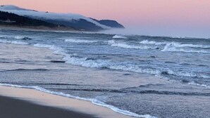 A beach with waves and a mountain in the background. - Beach Escape - Waldport (Waldport)