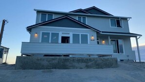 A two-story house with a balcony, a porch, and a number '206' on the front. - Beach Escape - Waldport (Waldport)