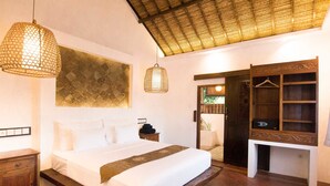 A bedroom with a bed, bedside table, hanging light, and a wardrobe. - The Mandana Gili Air (Gili Air)