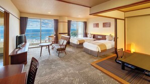 A hotel room with a large balcony, two beds, a desk, and a TV. - Kamenoi Hotel Atami (Atami)