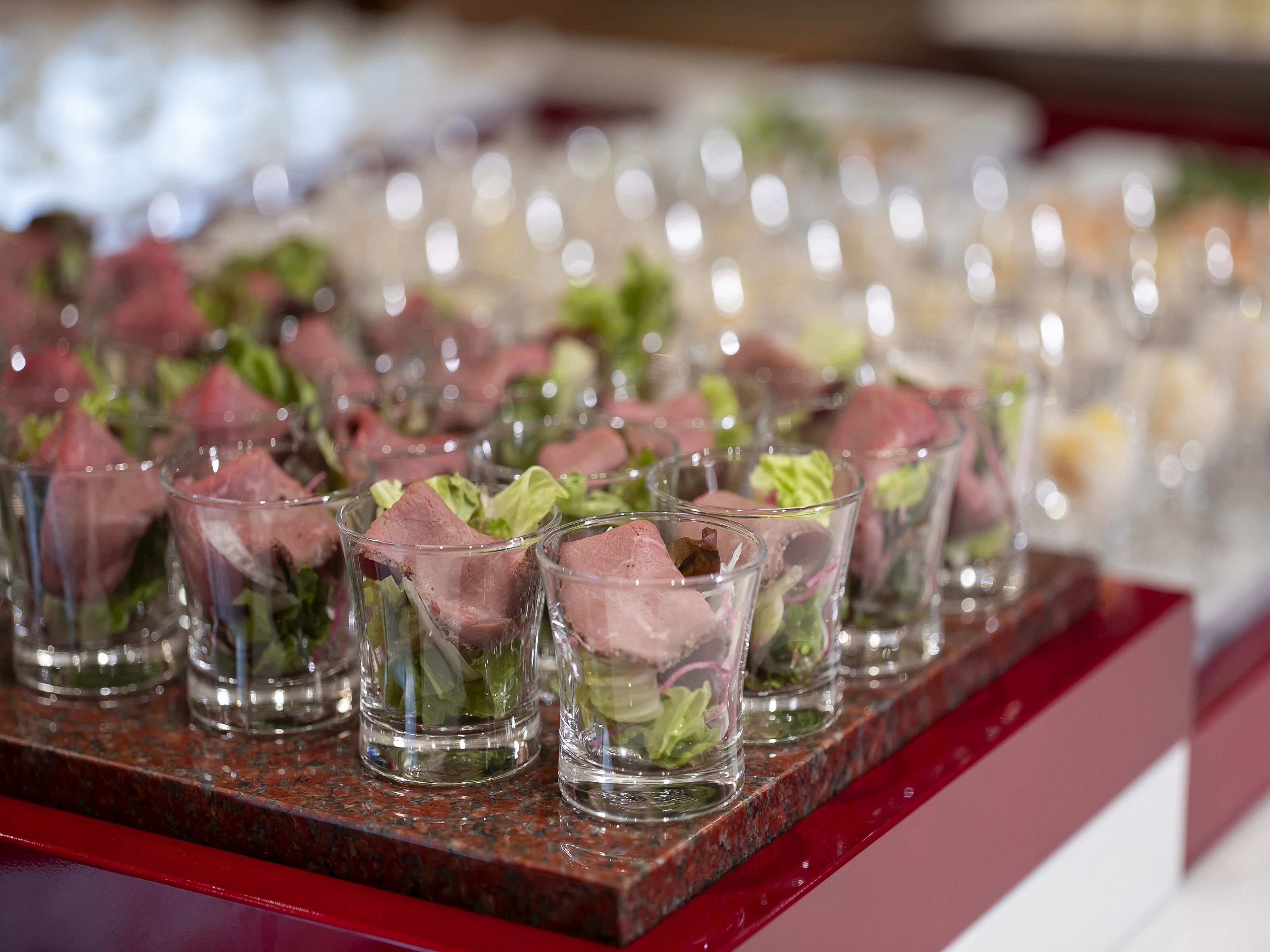 A buffet with small glass dishes containing food and garnishes.
