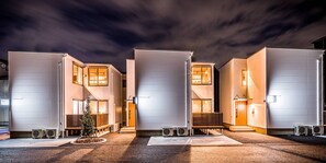 A row of modern, white buildings with large windows and air conditioning units in front. - Rakuten STAY HOUSE × WILL STYLE Takasaki (Takasaki)