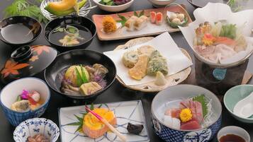 Diversos pratos japoneses, incluindo sushi, sashimi e tempura, servidos em cerâmica e laca tradicionais.