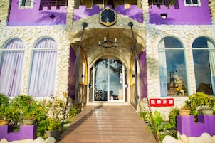 A building with a stone facade and arched entrance.