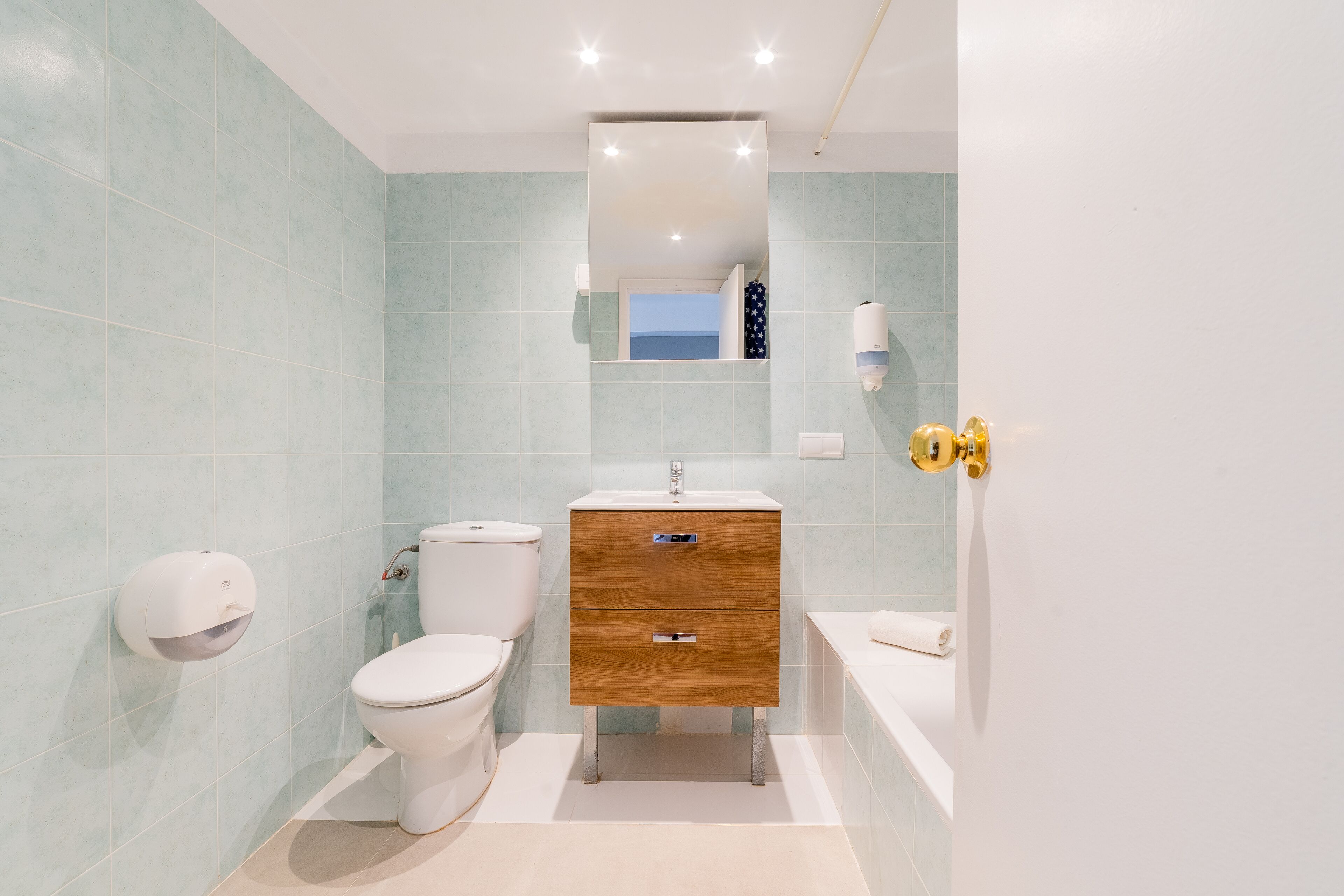 A modern bathroom with a toilet, sink, and vanity.