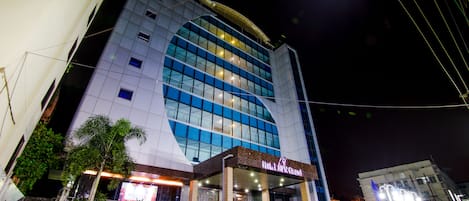 A hotel with a modern facade, large windows, and a prominent logo.