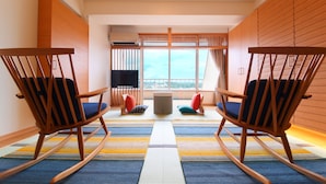A modern room with two rocking chairs, a large window, and a view of the city. - Bansyoukaku Shikishima (Ureshino)