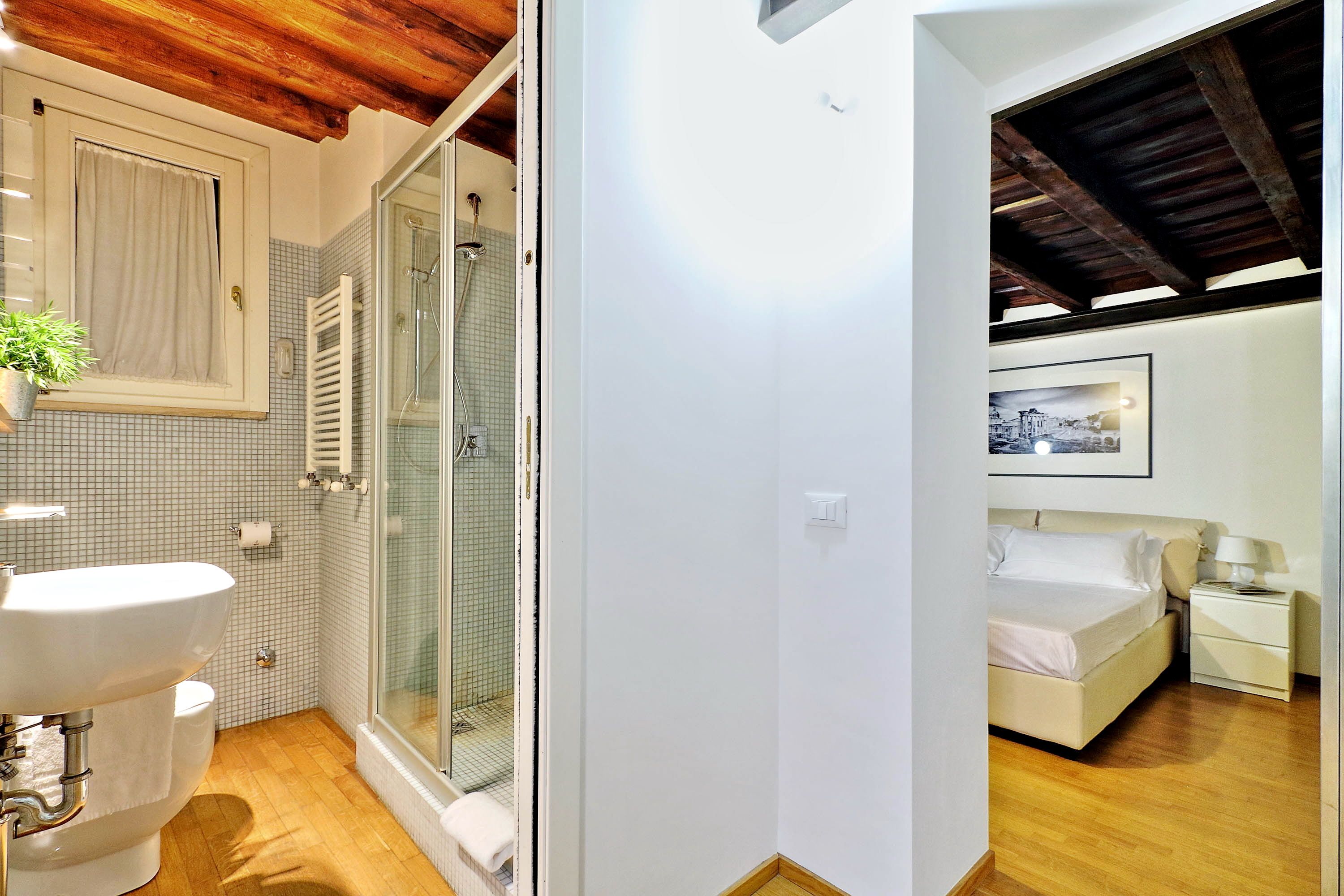 A bathroom with a sink, toilet, and shower.