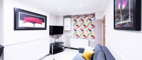 Apartment, 1 Bedroom (Flat 1) | Living area | Flat-screen TV