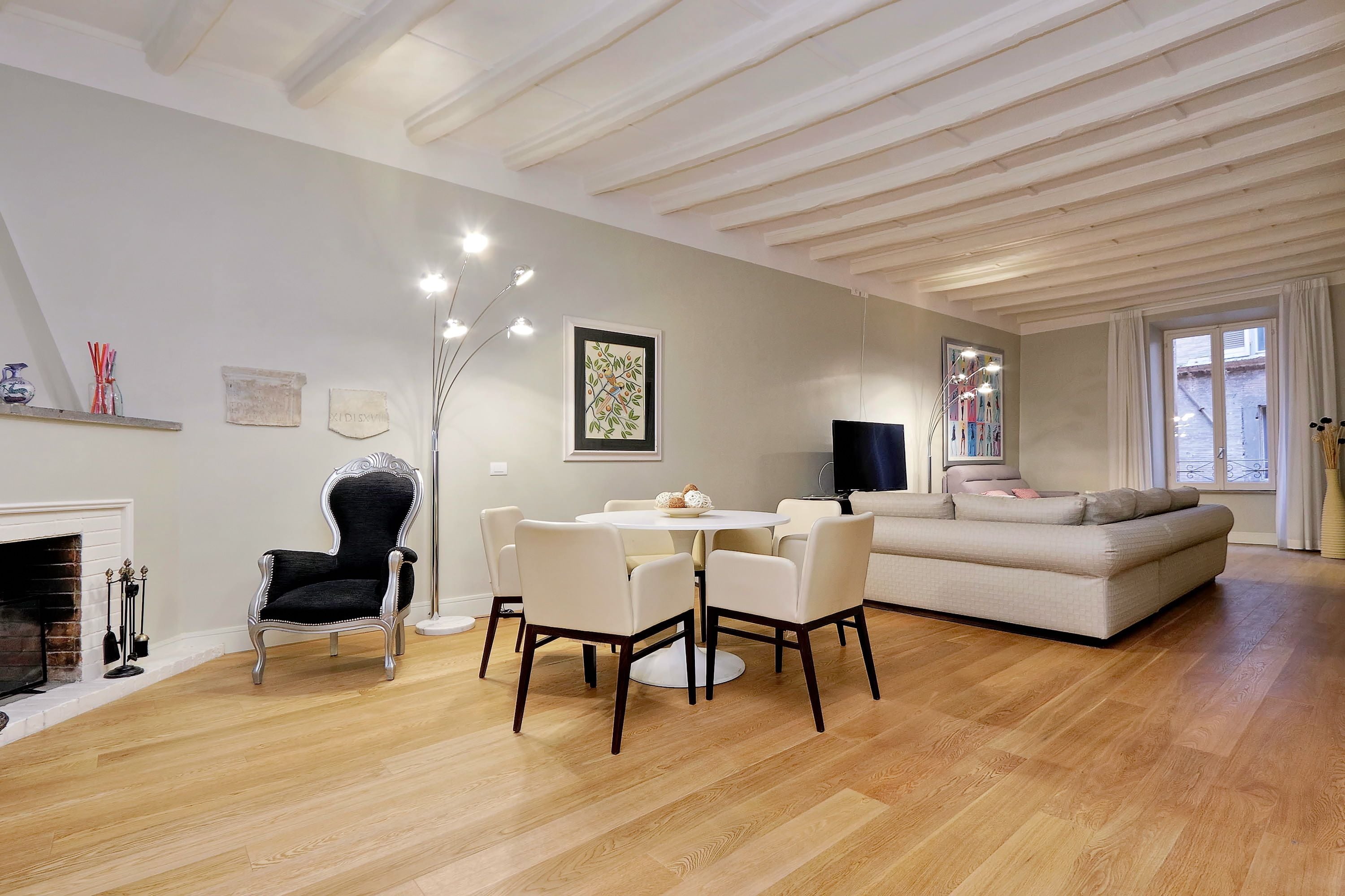 Un salon moderne avec une cheminée, une table à manger ronde et un canapé.