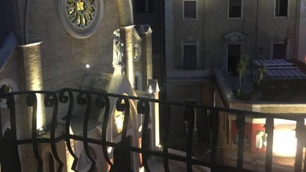 A building with a clock tower and a mural on the facade. - La Capitale B&B (Rome)