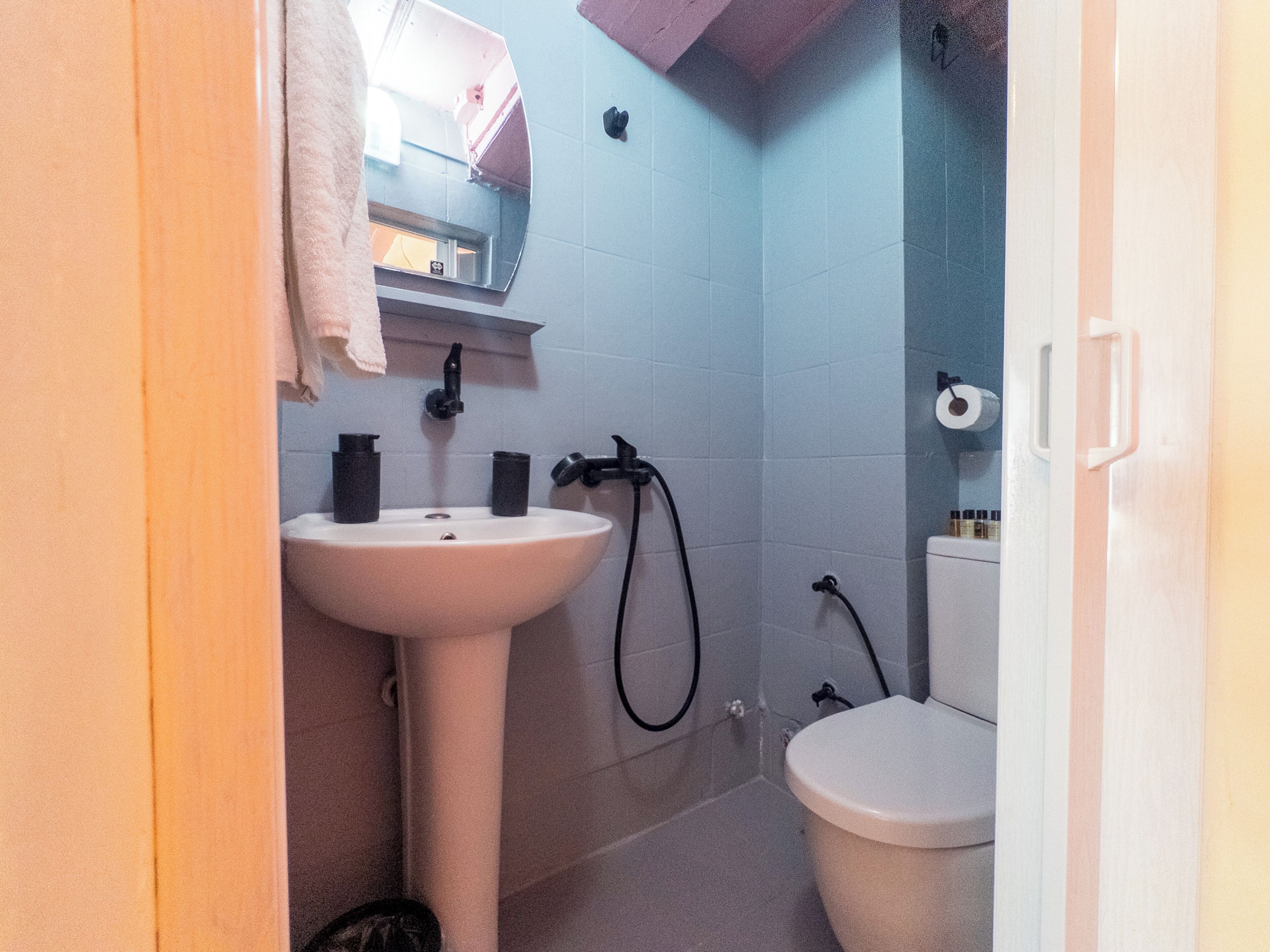A bathroom with a sink, toilet, and shower.