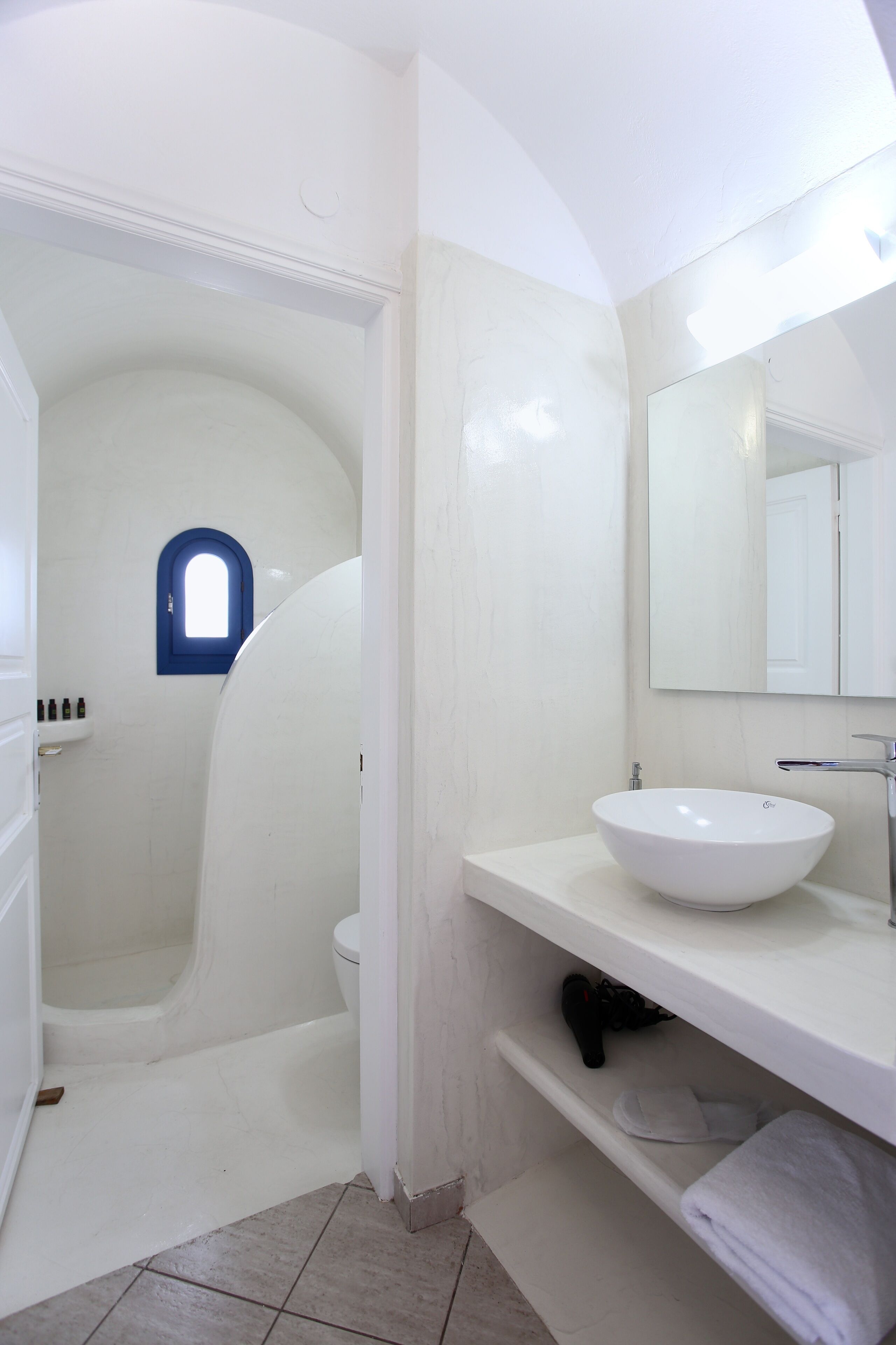 A bathroom with a white sink, a mirror, and a bathtub.