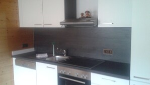 Apartment, Balcony | Private kitchen | Coffee/tea maker, full-size fridge, oven, stovetop - Drechslerhaus (Sankt Johann in Tirol)