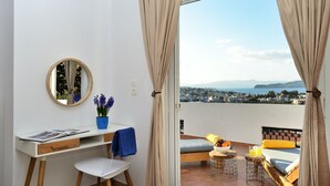 A bedroom with a view of a cityscape, a desk with a mirror, a potted plant, and a bed with a view. - Villa ANVA, amazing views, walk to the beach (Daratsos)